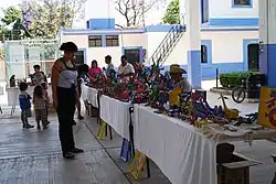 Woman looking at Alebrijes for sale at the weekly market