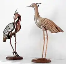 Carved wooden cranes