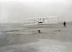 An airplane flying on a beach