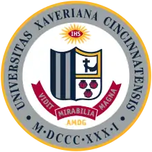 The Xavier University seal, like the St. Xavier seal, bears the schools' coat of arms, which consists of five vertical stripes, an arm holding a crucifix, and three seashells.