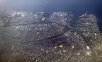 An aerial view north-west of the Port of Chiba (Cosmo Chiba refinery seen left of the river mouth)