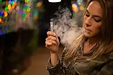 A person using a Juul device.