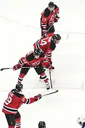 New Jersey Devils forward Travis Zajac (#19, foreground) instructs Nick Palmieri (#32), Mark Fayne (#34), and Ilya Kovalchuk (#17) prior to faceoff