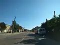 A street in Zaliznyi Port with cars parked along it