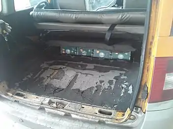 Wear and tear in the battery compartment of a Zotye M300 EV, located in the trunk.