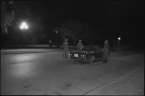 Three soldiers are pictured at a road checkpoint at the campus entrance