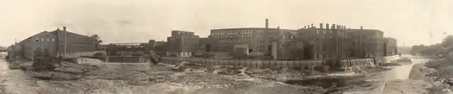 Three factories on elevated ground above the Black River